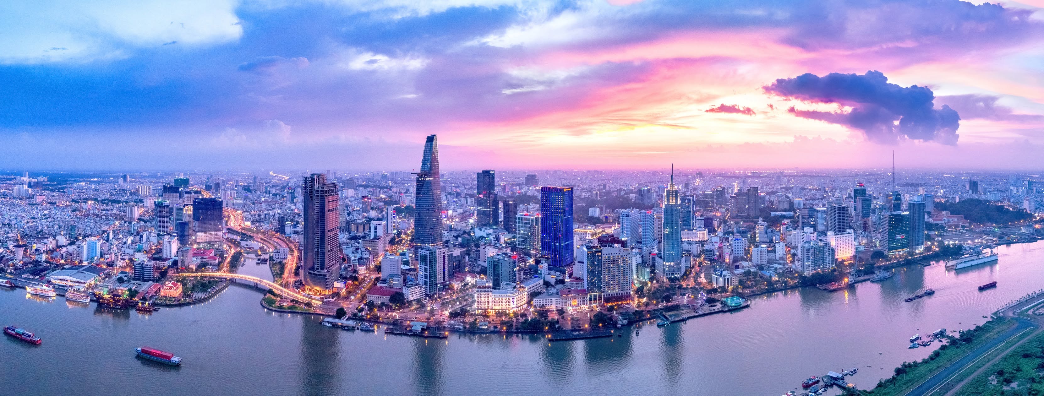 The Ho Chi Minh City skyline along the Saigon River at sunset